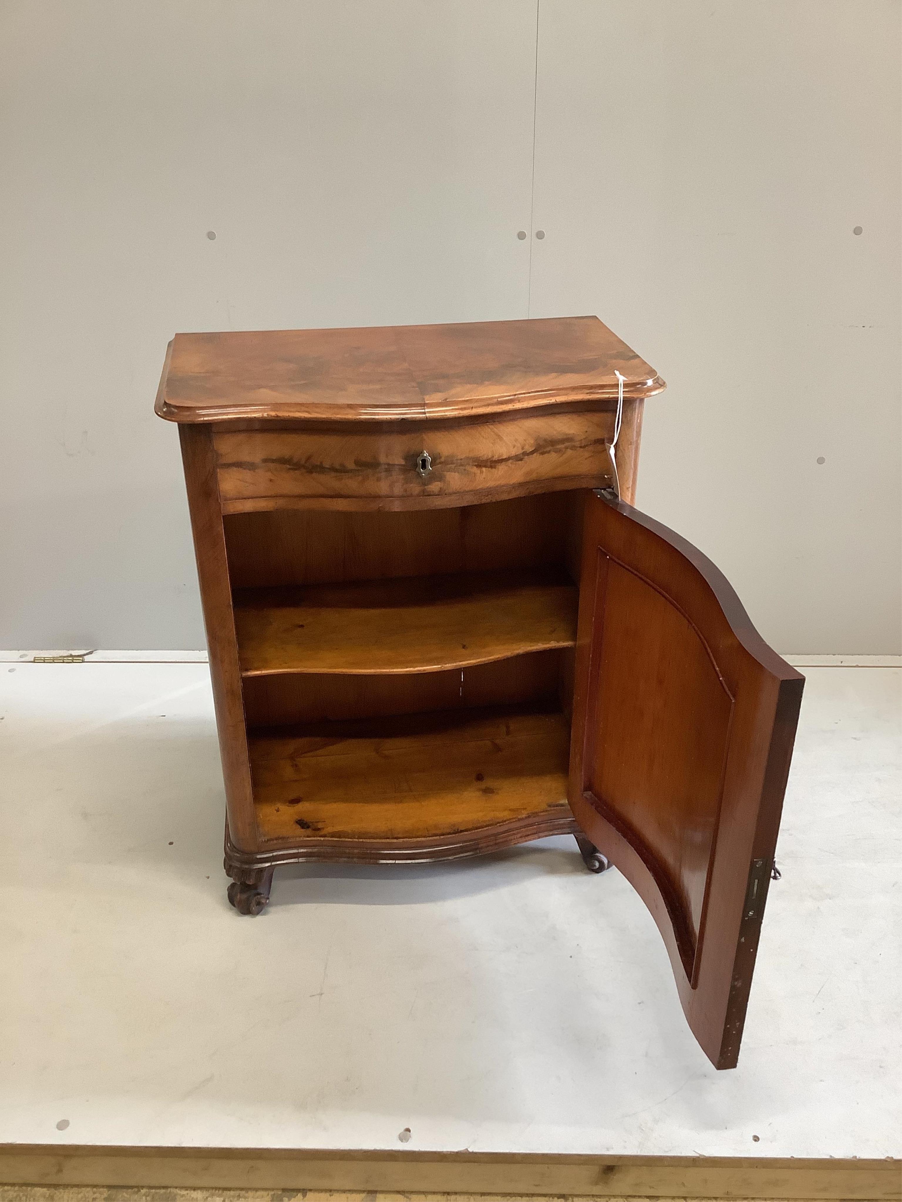 A 19th century French mahogany serpentine fronted side cabinet, with frieze drawer above a cupboard, on scrolled feet, width 66cm, depth 38cm, height 83cm. Condition - fair-good